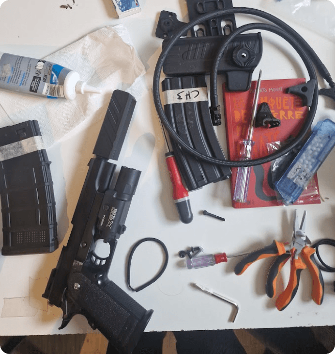 Airsoft internals and tools laid out on the workbench